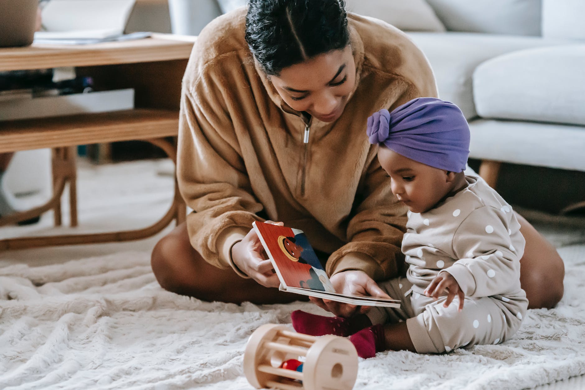 mother and baby girl reading a book